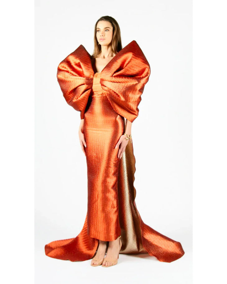 Woman wearing vibrant orange Grace 3D Shoulder Bow gown with dramatic back tail — Anaya Collection | Endless UAE