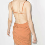 Peach asymmetrical dress with ruched side detail and open back, rear view on model — Jacquemus | Endless UAE