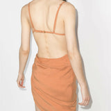 Peach asymmetrical dress with ruched side detail and open back, rear view on model — Jacquemus | Endless UAE