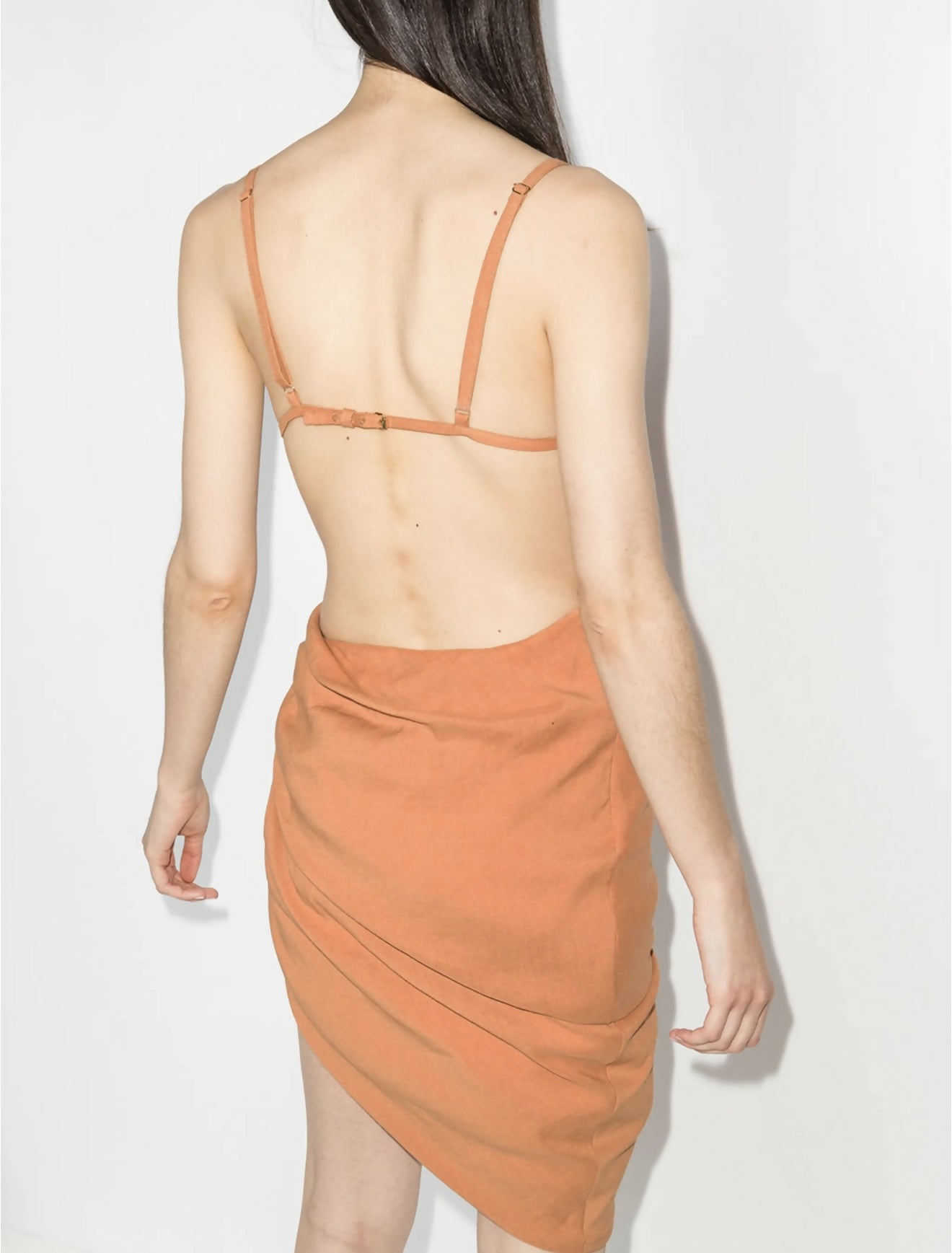 Peach asymmetrical dress with ruched side detail and open back, rear view on model — Jacquemus | Endless UAE