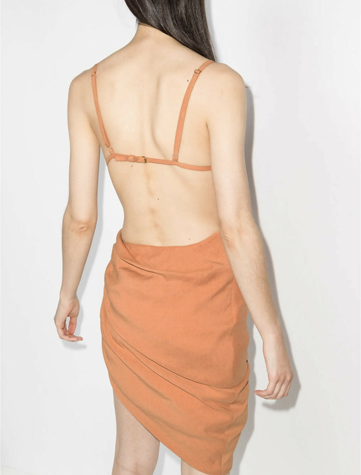 Peach asymmetrical dress with ruched side detail and open back, rear view on model — Jacquemus | Endless UAE