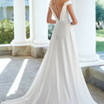 Off-shoulder white wedding dress with ruched bodice and flowing skirt — Justin Alexander | Endless UAE