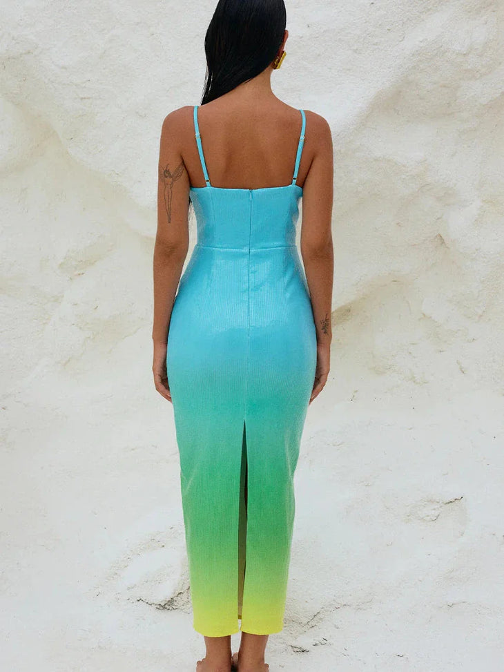 Woman wearing turquoise to yellow ombre sequin bodycon midi dress with thin straps and back slit, view from behind — Runaway | Endless UAE