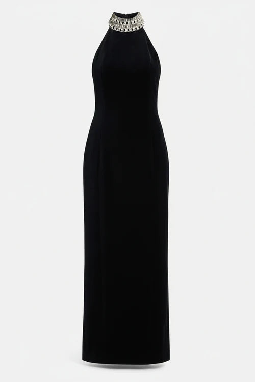 Woman wearing black halter neck velvet evening dress standing in front of historic building — COPURS | Endless UAE