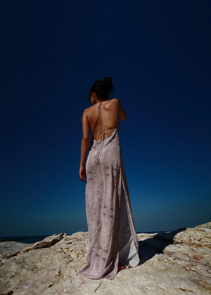 Woman wearing grey Gisele Dress standing on beach with clear blue sea — Dvete | Endless UAE