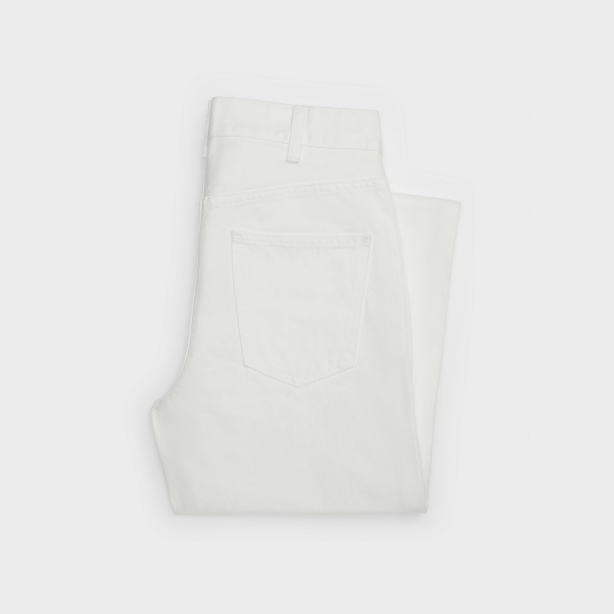 Folded white denim jeans with visible back pocket detail — Celine | Endless UAE