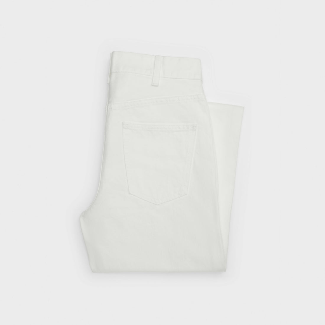 Folded white denim jeans with visible back pocket detail — Celine | Endless UAE