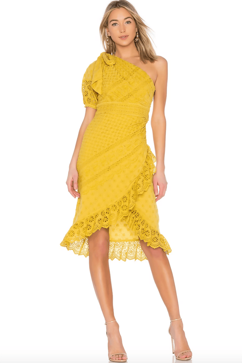 Woman wearing yellow one-shoulder eyelet lace dress with ruffle details and asymmetric hem, paired with nude heels — Ulla Johnson | Endless UAE