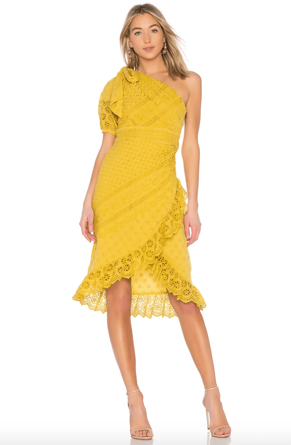Woman wearing yellow one-shoulder eyelet lace dress with ruffle details and asymmetric hem, paired with nude heels — Ulla Johnson | Endless UAE