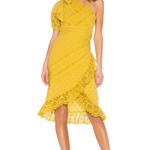 Woman wearing yellow one-shoulder eyelet lace dress with ruffle details and asymmetric hem, paired with nude heels — Ulla Johnson | Endless UAE