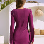 Woman wearing purple long-sleeved Nerida dress from behind in outdoor setting with white walls and plants — Beach City | Endless UAE