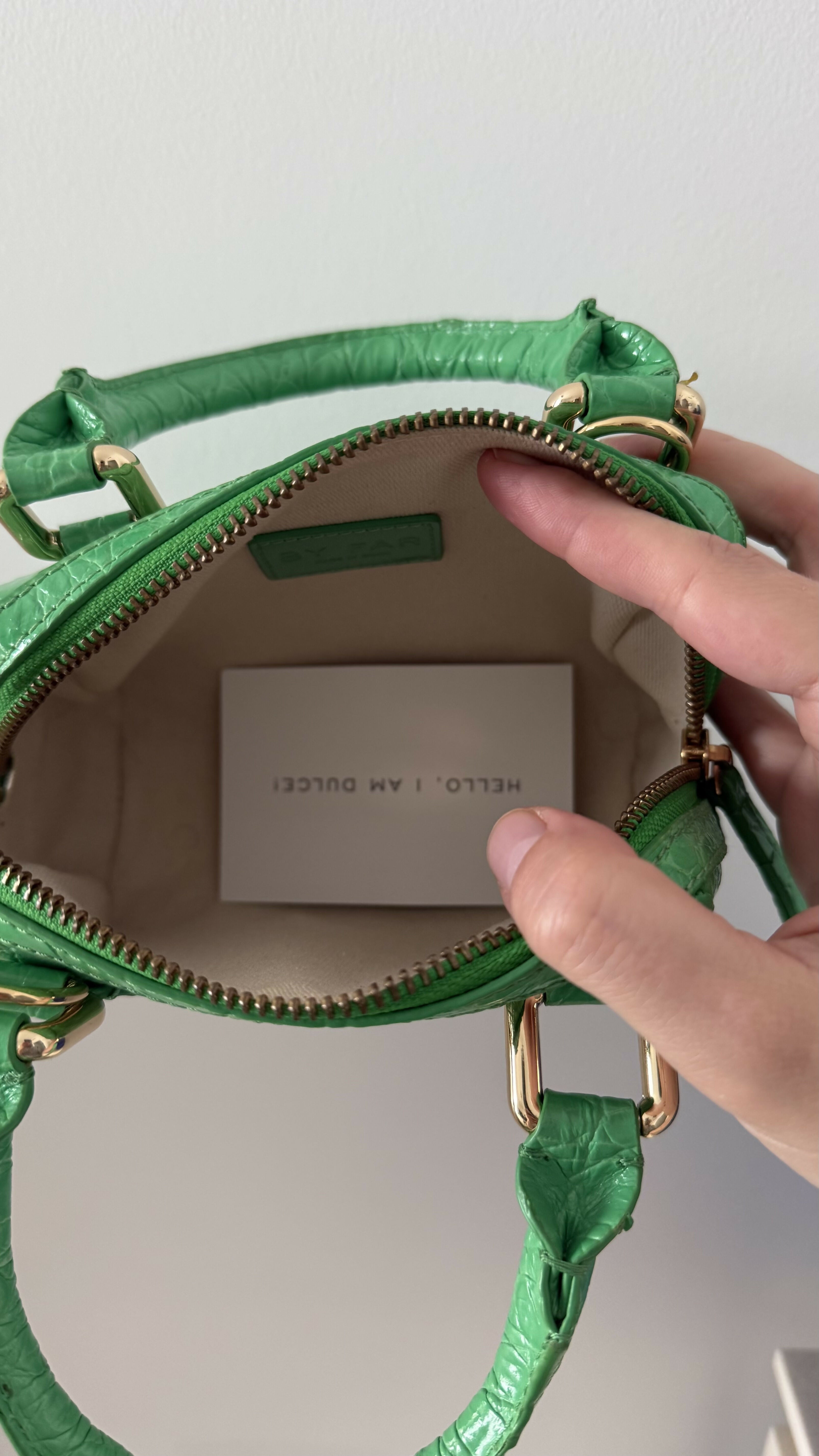 Green crocodile-embossed mini tote bag with gold hardware held by hand — By Far | Endless UAE