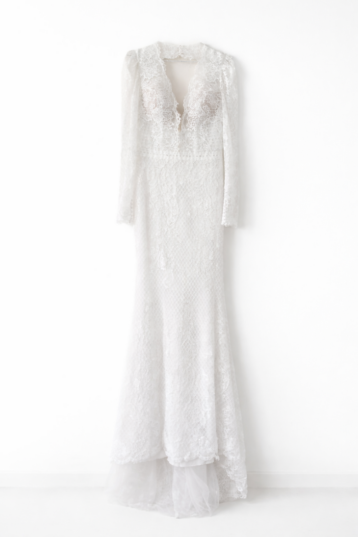 Elegant white lace wedding dress with long sleeves and flowing tulle train — Tatiana Kaplun | Endless UAE
