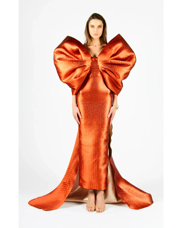 Woman wearing vibrant orange Grace 3D Shoulder Bow gown with dramatic back tail — Anaya Collection | Endless UAE