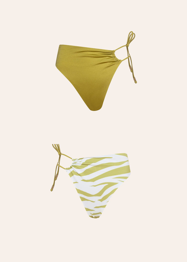 Reversible bikini bottom in solid chartreuse green and green-white zebra stripe print with side ties — Dvete | Endless UAE
