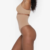 Woman wearing beige high waist thong in standing pose — Underhance | Endless UAE