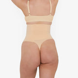 Woman wearing beige high waist thong in standing pose — Underhance | Endless UAE
