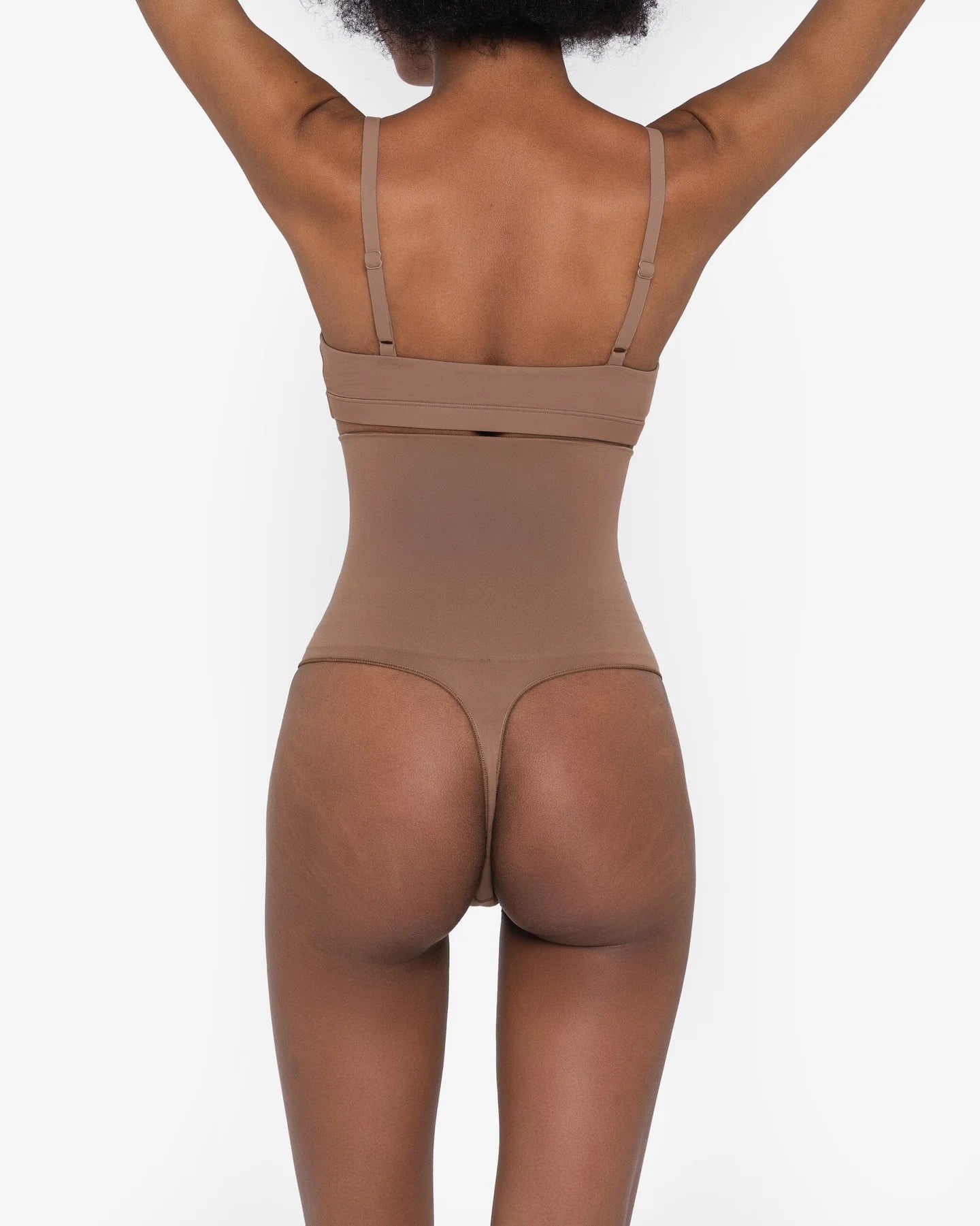 Woman wearing beige high waist thong in standing pose — Underhance | Endless UAE