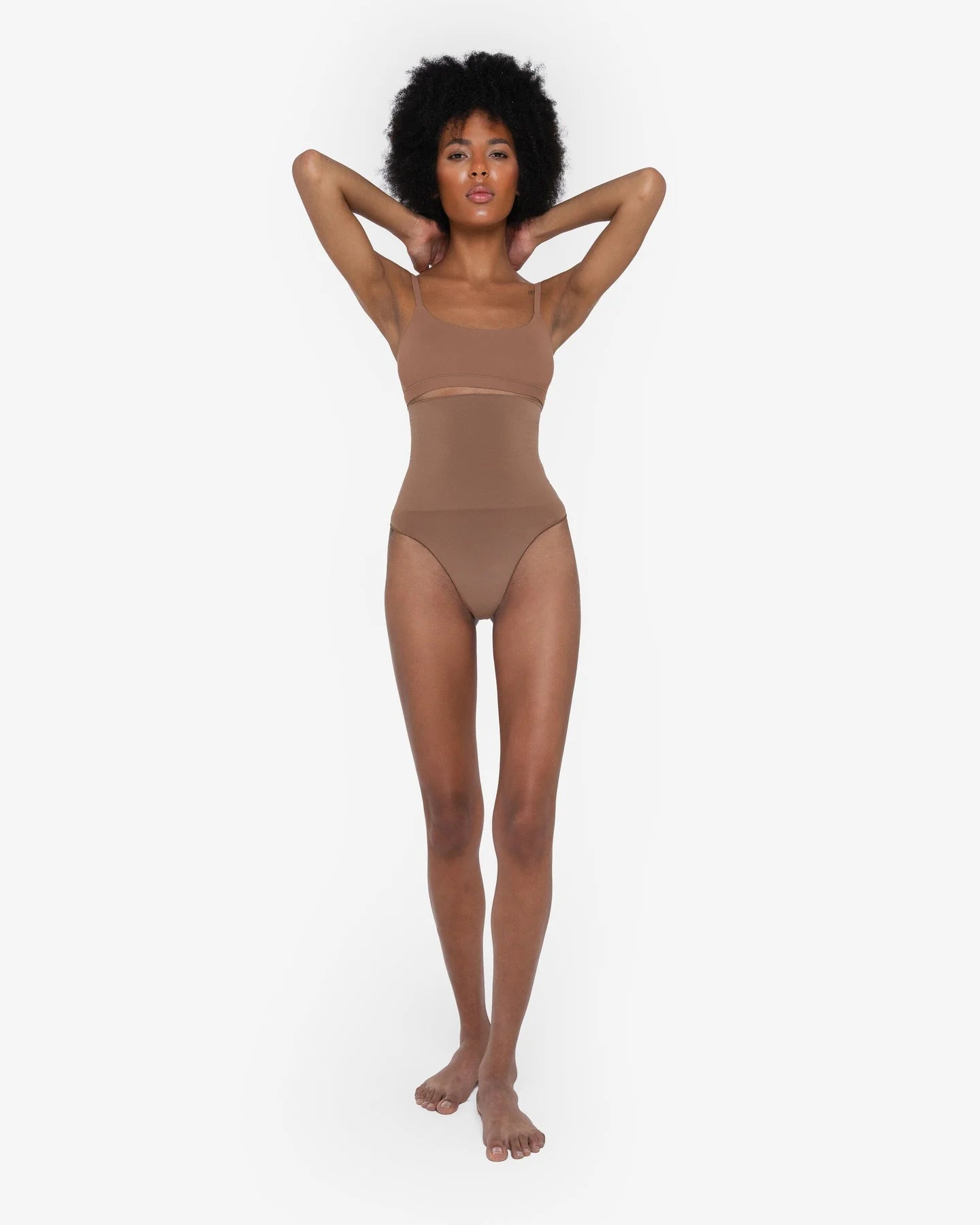 Woman wearing beige high waist thong in standing pose — Underhance | Endless UAE