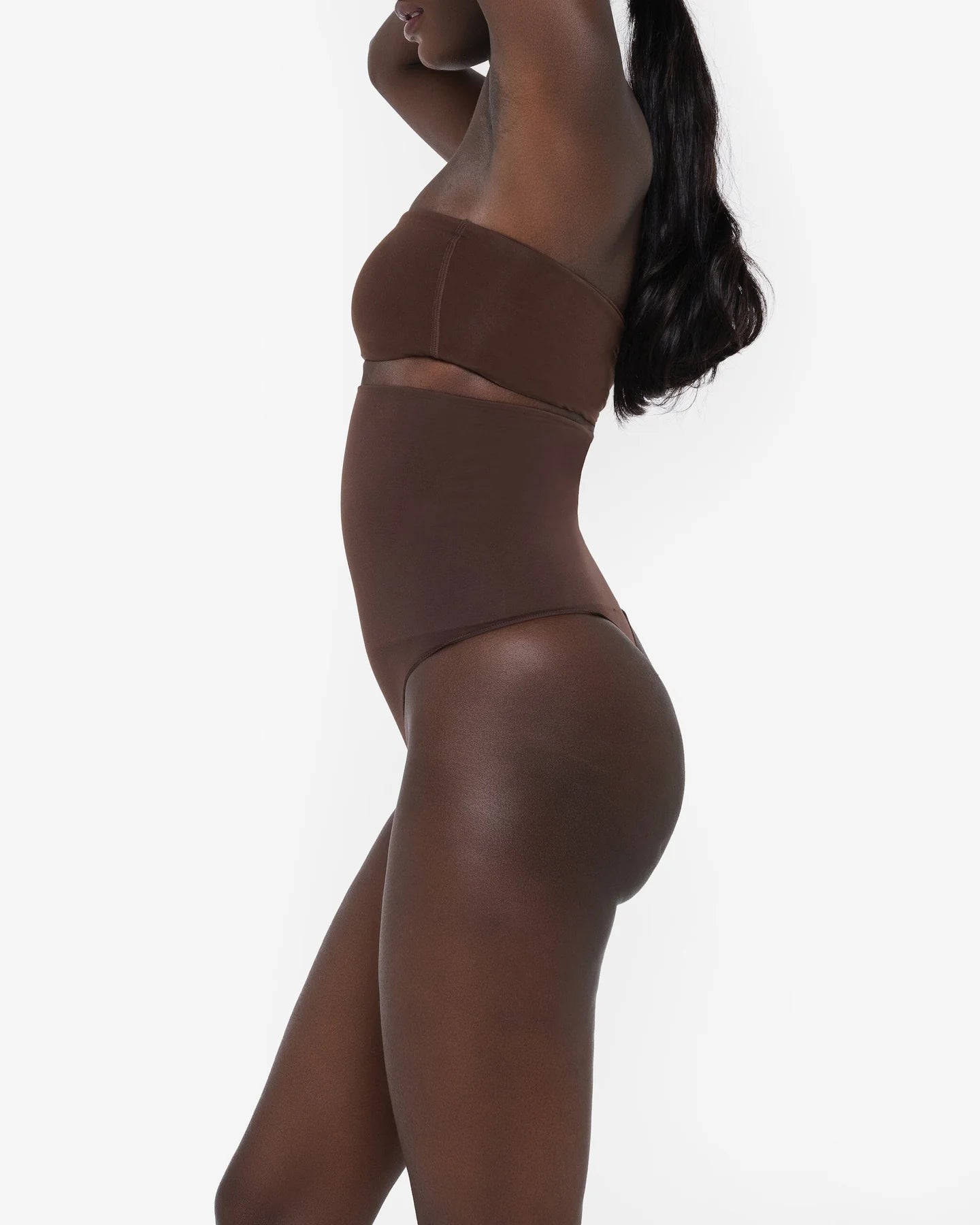 Woman wearing beige high waist thong in standing pose — Underhance | Endless UAE