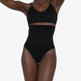 Woman wearing beige high waist thong in standing pose — Underhance | Endless UAE