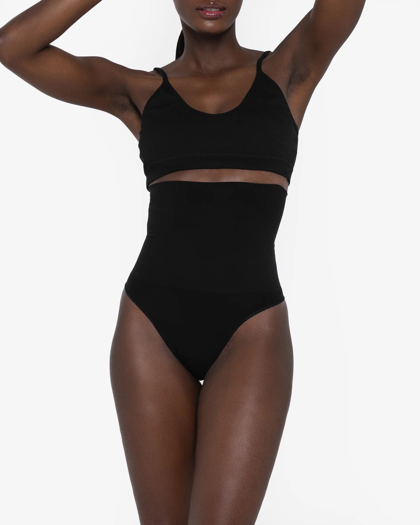 Woman wearing beige high waist thong in standing pose — Underhance | Endless UAE