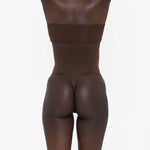 Woman wearing beige high waist thong in standing pose — Underhance | Endless UAE