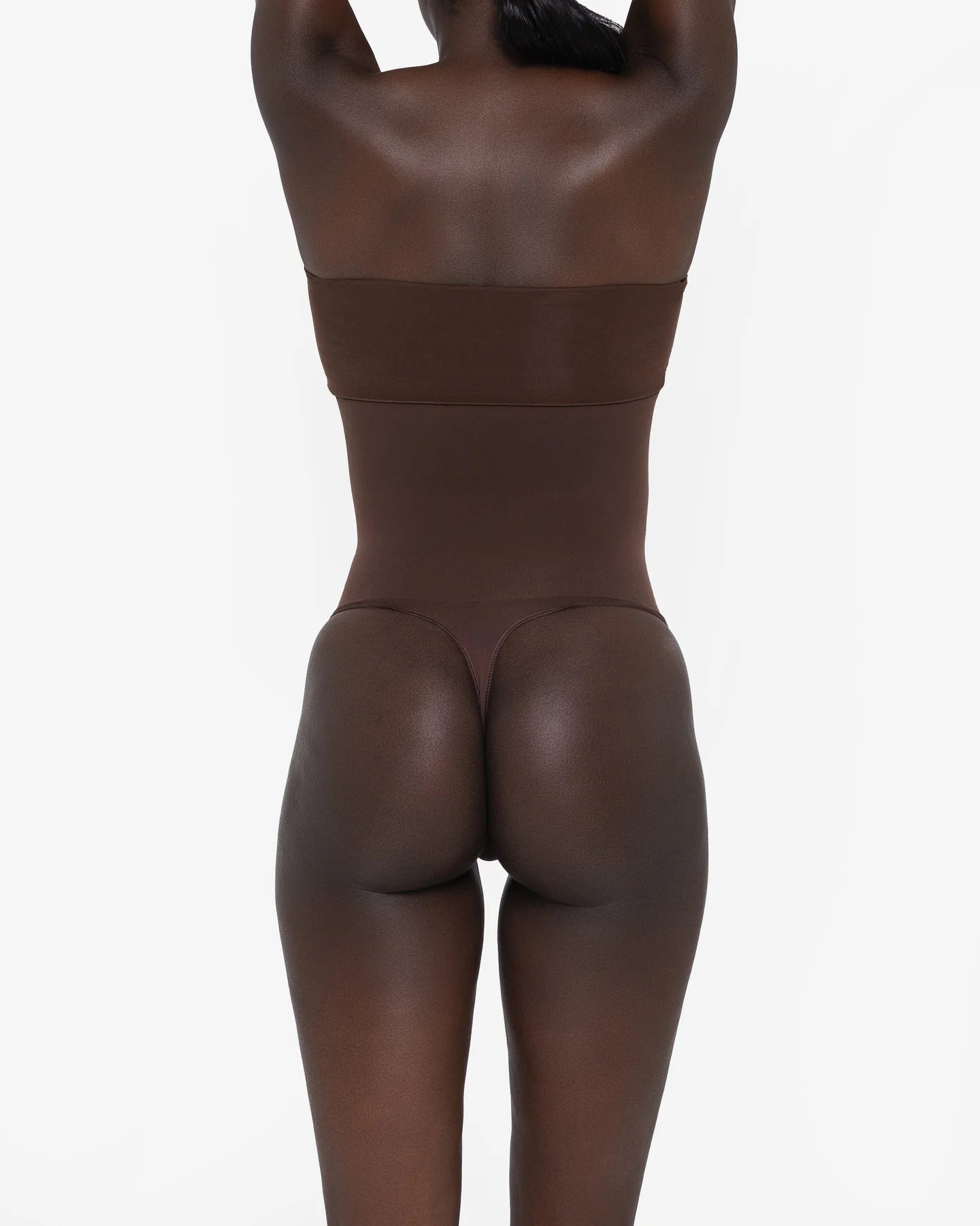 Woman wearing beige high waist thong in standing pose — Underhance | Endless UAE