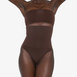 Woman wearing beige high waist thong in standing pose — Underhance | Endless UAE