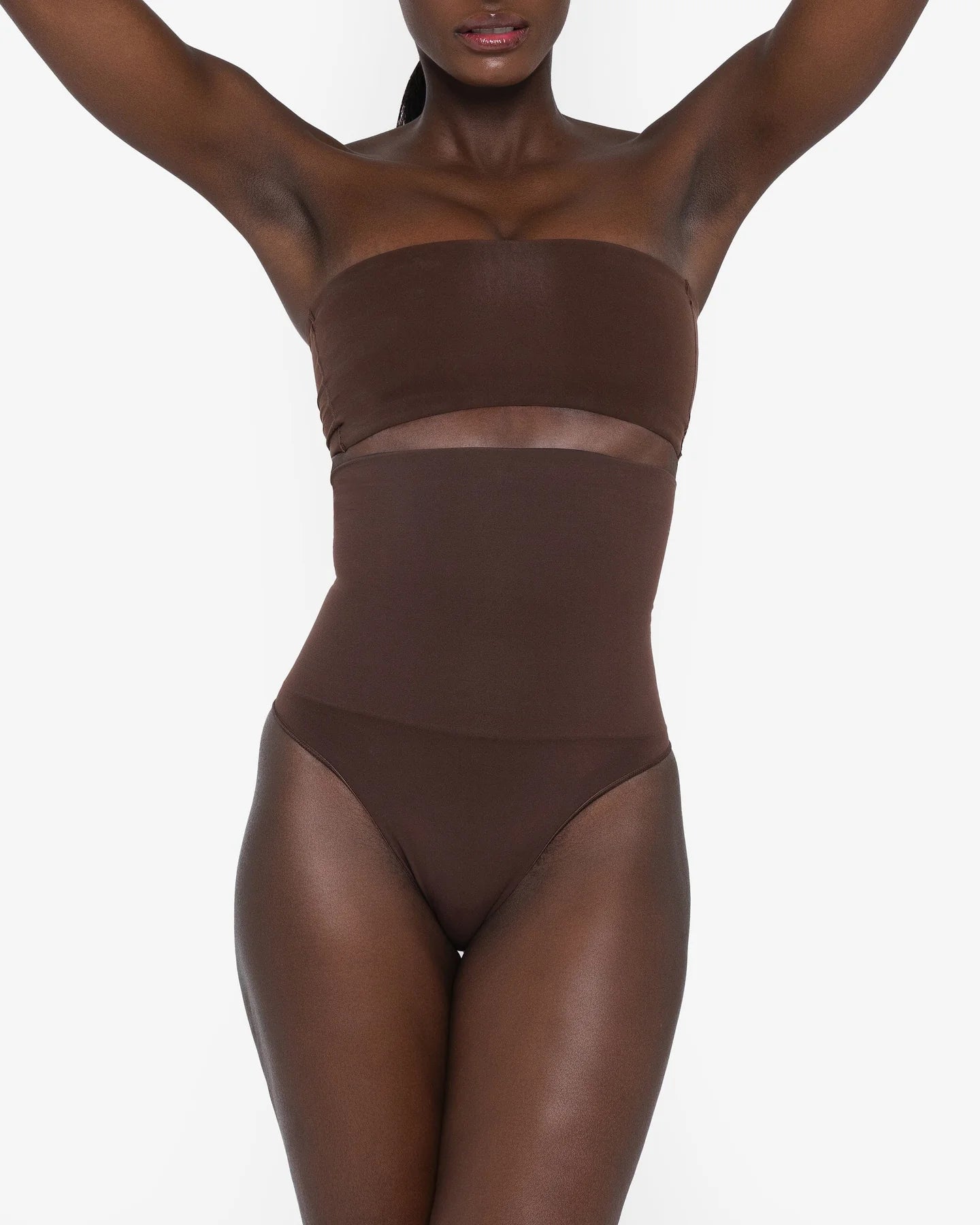 Woman wearing beige high waist thong in standing pose — Underhance | Endless UAE