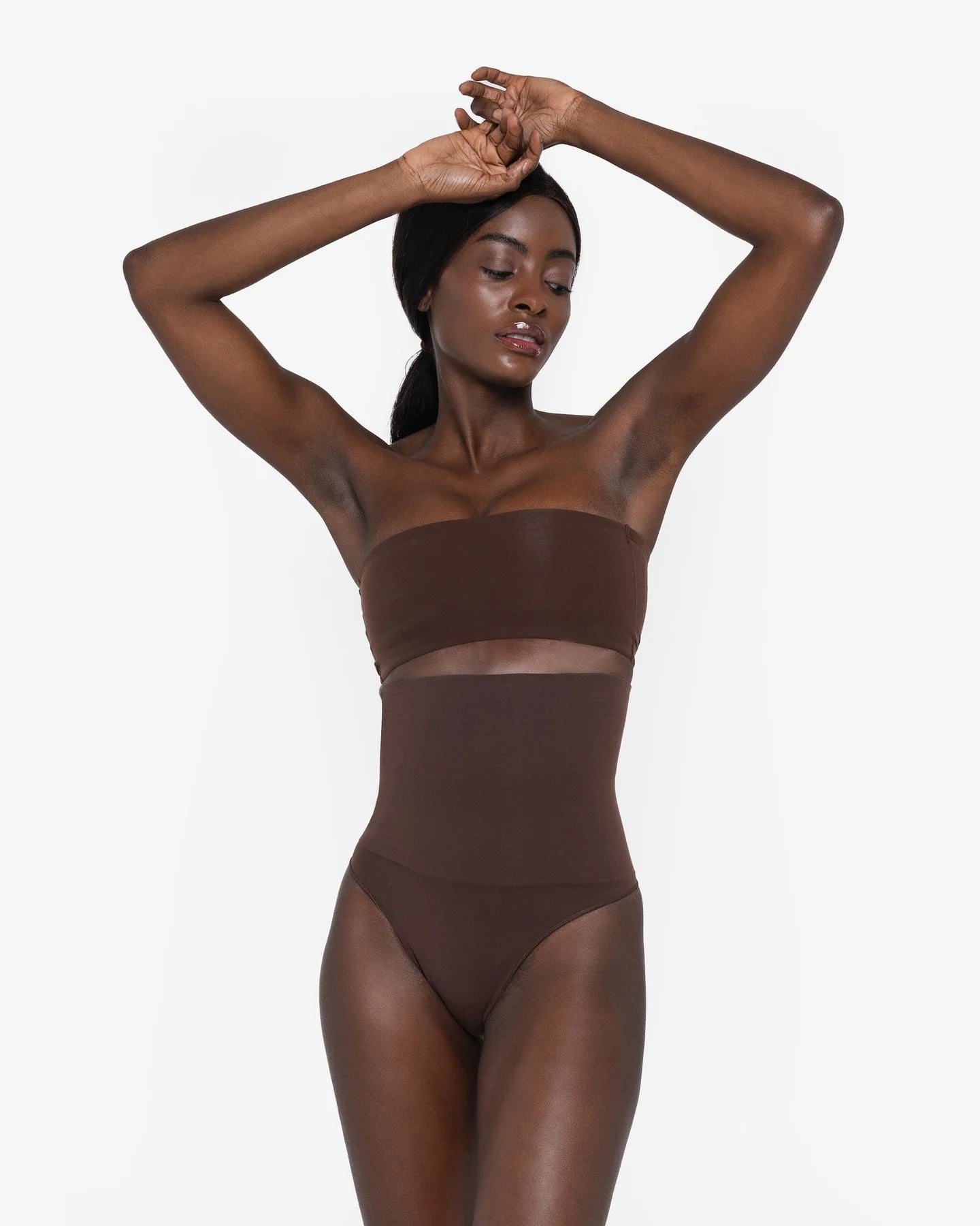 Woman wearing beige high waist thong in standing pose — Underhance | Endless UAE