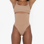 Woman wearing beige high waist thong in standing pose — Underhance | Endless UAE
