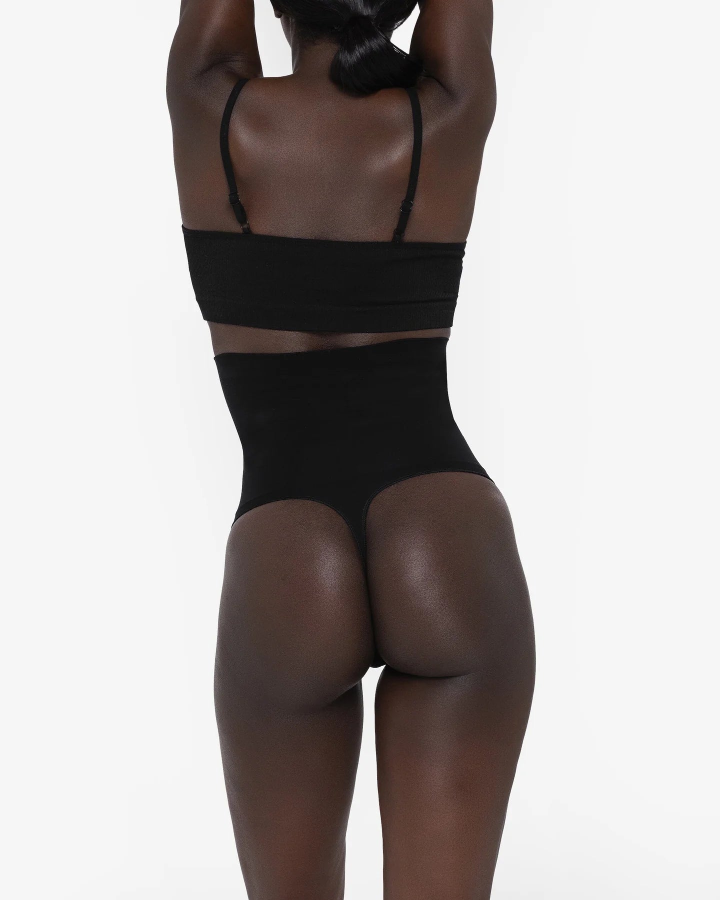 Woman wearing beige high waist thong in standing pose — Underhance | Endless UAE
