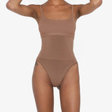Woman wearing beige high waist thong in standing pose — Underhance | Endless UAE