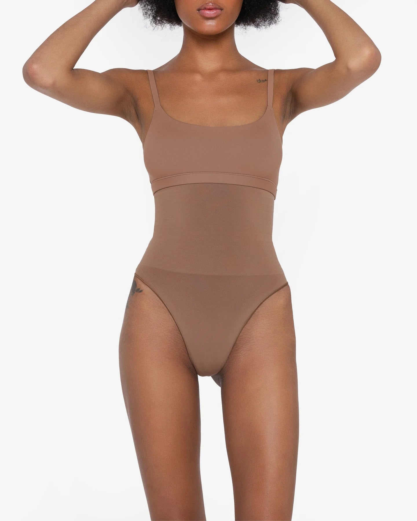 Woman wearing beige high waist thong in standing pose — Underhance | Endless UAE