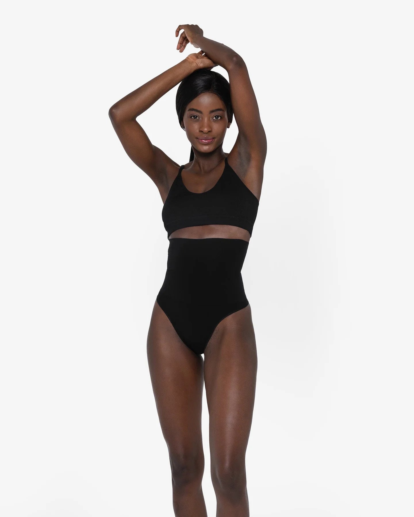 Woman wearing beige high waist thong in standing pose — Underhance | Endless UAE