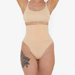 Woman wearing beige high waist thong in standing pose — Underhance | Endless UAE
