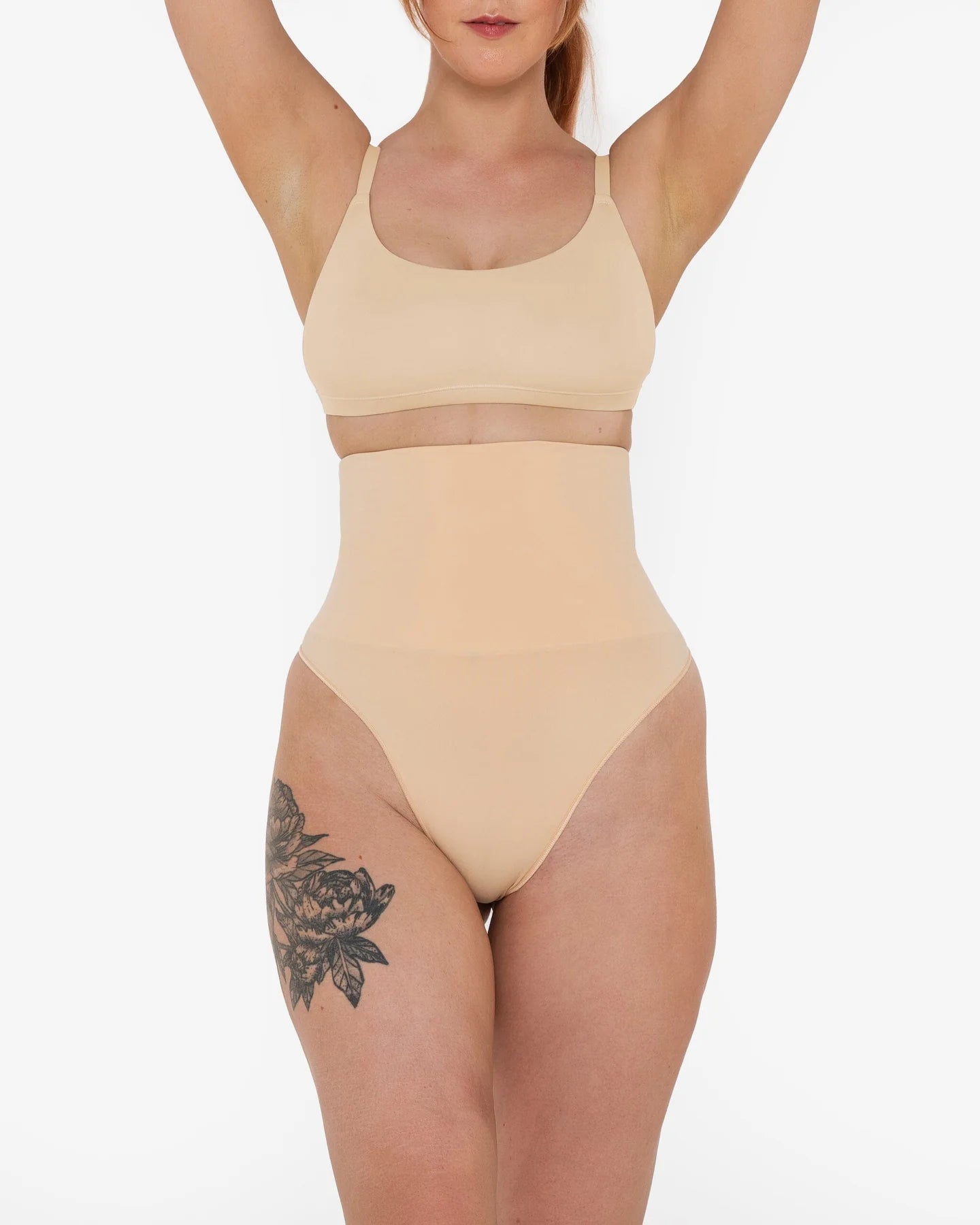 Woman wearing beige high waist thong in standing pose — Underhance | Endless UAE