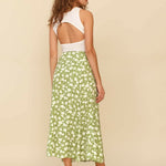 Woman wearing white sleeveless tank top and green floral midi skirt with side slit — Endless | Endless UAE