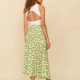 Woman wearing white sleeveless tank top and green floral midi skirt with side slit — Endless | Endless UAE