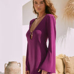 Purple metallic mini dress with plunging neckline and long sleeves in white Mediterranean setting — Beach City | Endless UAE