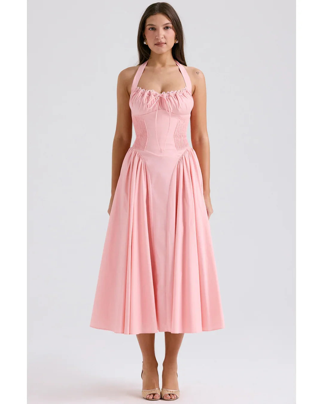Woman wearing rose pink cotton halter midi sundress with ruched neckline and full skirt — House of CB | Endless UAE