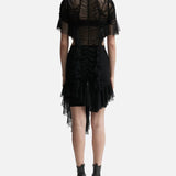 Black ruched dress with sheer tulle overlay, asymmetric hem, and short sleeves, shown from back — Ester Manas | Endless UAE