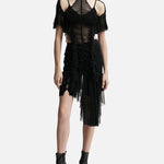 Black ruched dress with sheer mesh overlay, cold shoulder sleeves, and asymmetric hem on model — Ester Manas | Endless UAE