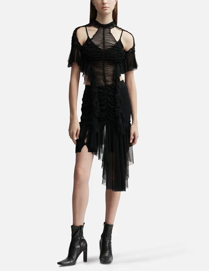 Black ruched dress with sheer mesh overlay, cold shoulder sleeves, and asymmetric hem on model — Ester Manas | Endless UAE