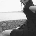 Woman wearing black sleeveless belted maxi dress by the seaside — LA Collection | Endless UAE