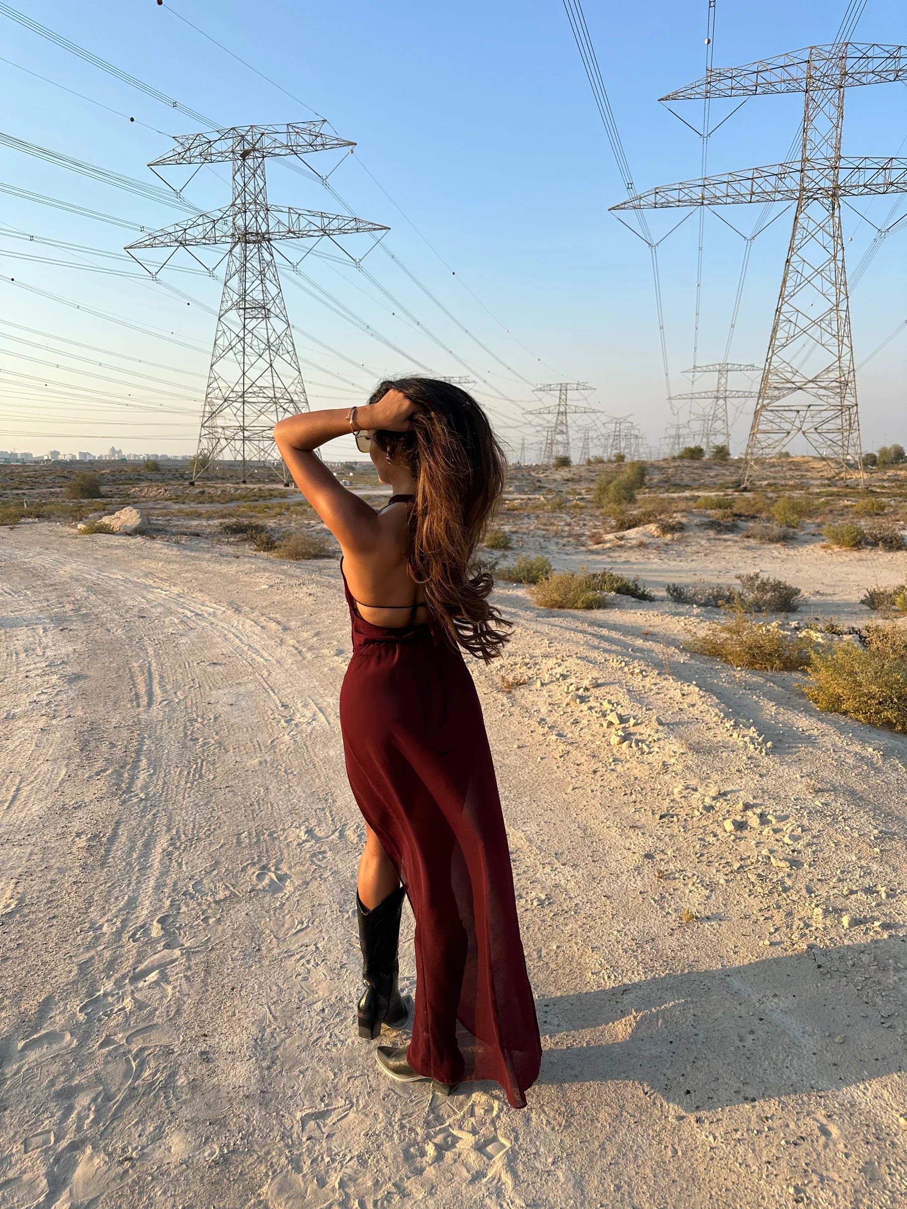 Brown La Musique Halter Neck Sheer Dress worn by woman posing in desert with power lines — Scorpio Rizing | Endless UAE