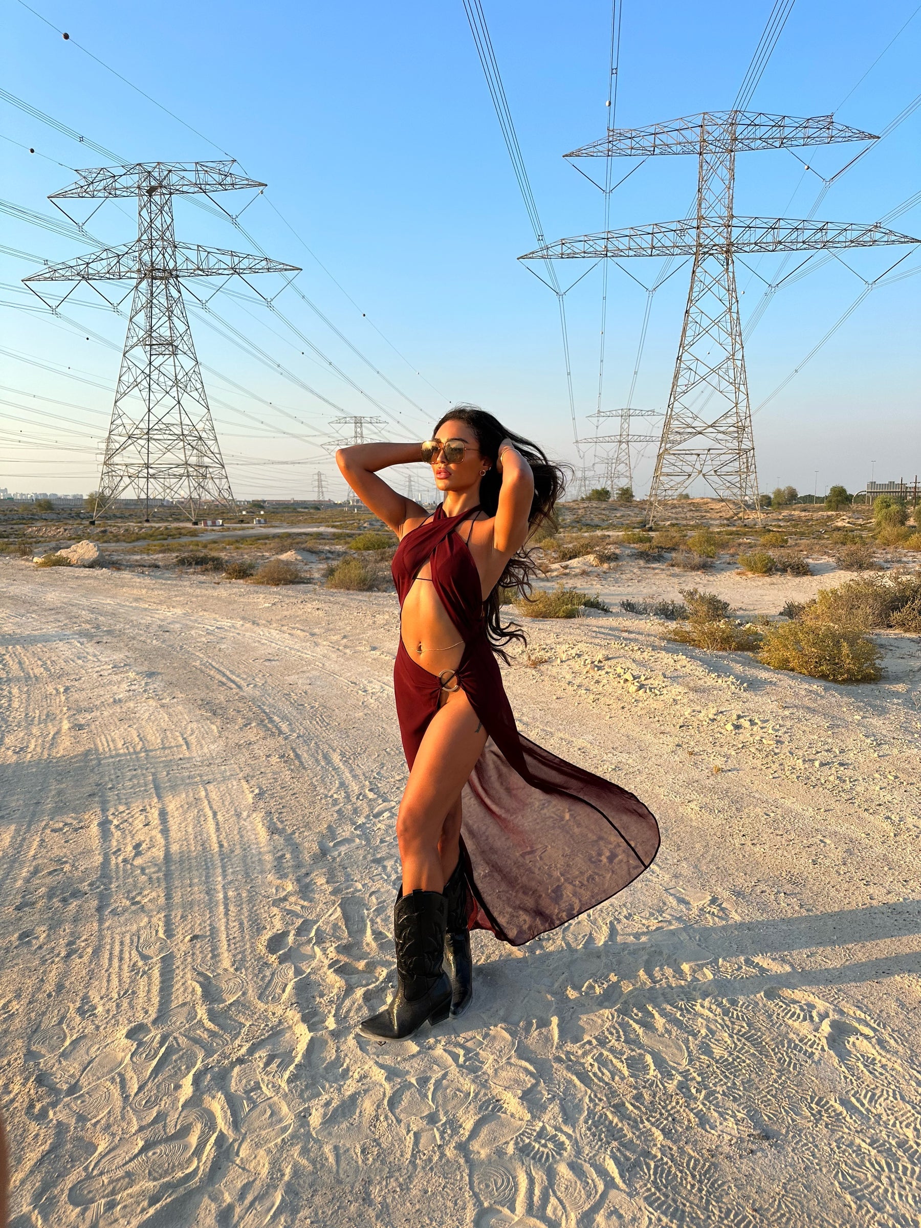 Brown La Musique Halter Neck Sheer Dress worn by woman posing in desert with power lines — Scorpio Rizing | Endless UAE