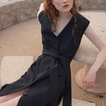 Woman wearing black sleeveless belted maxi dress by the seaside — LA Collection | Endless UAE
