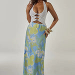 Woman wearing white halter cut-out crop top with blue and green floral maxi skirt — Runaway The Label | Endless UAE